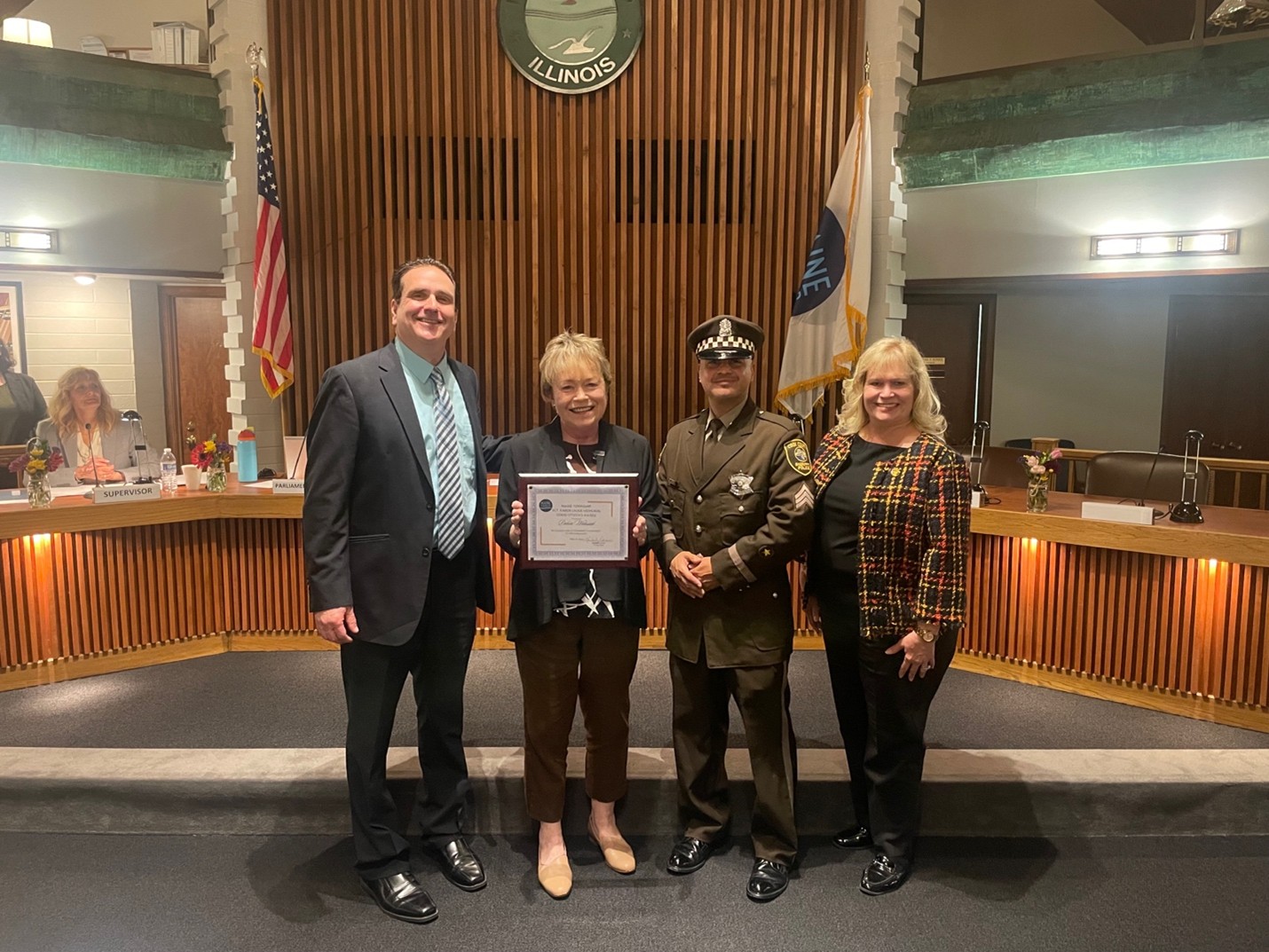 Maine Township resident and former Director of the Des Plaines Self-Help Closet and Pantry Debbie Walusiak accepts the Sgt. Karen Lader Memorial Good Citizen Award. Pictured from Left: Maine Township Clerk Pete Gialamas, Debbie Walusiak and Cook County Sheriff&rsquo;s Office officials